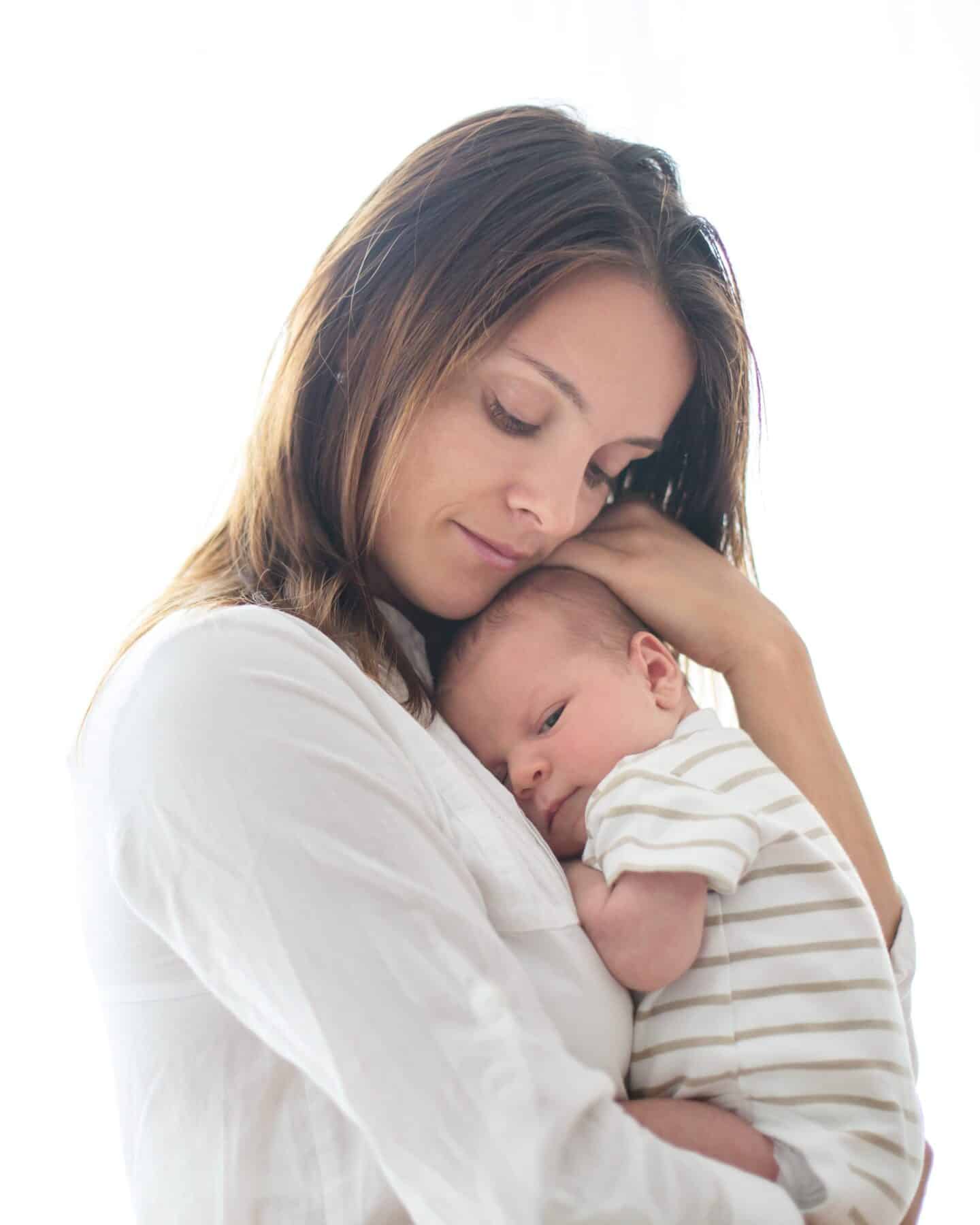 Young mother, holding her newborn baby boy